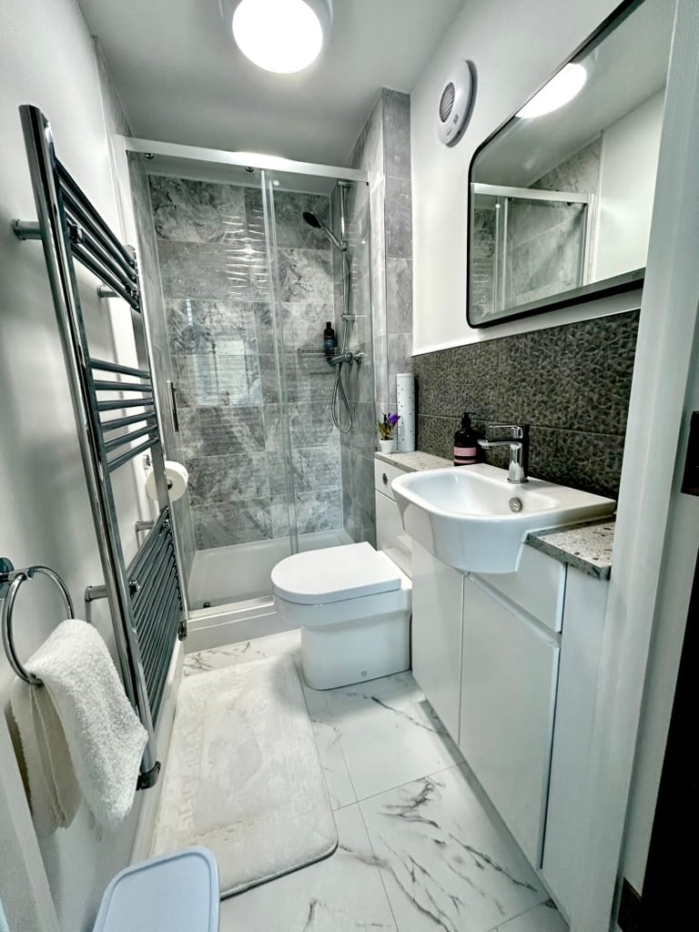 Modern bathroom with walk-in shower at Sweet Cottage