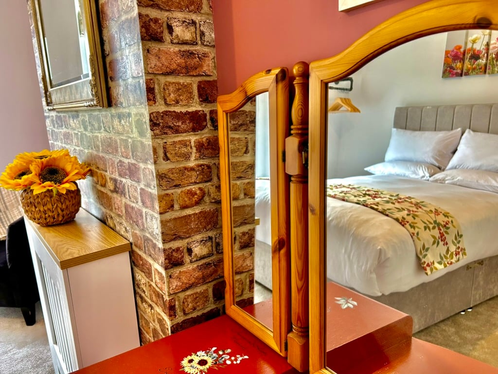 Dressing area and double bedroom at Sweet Cottage