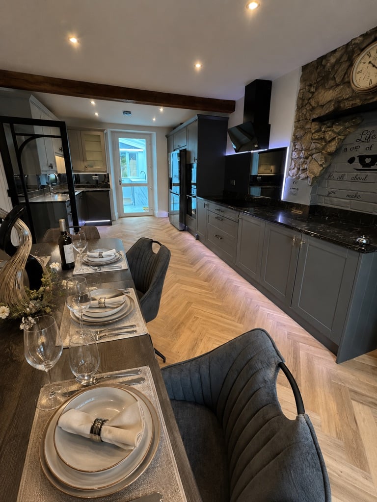 Modern kitchen and dining table prepared for guests at Sweet Cottage